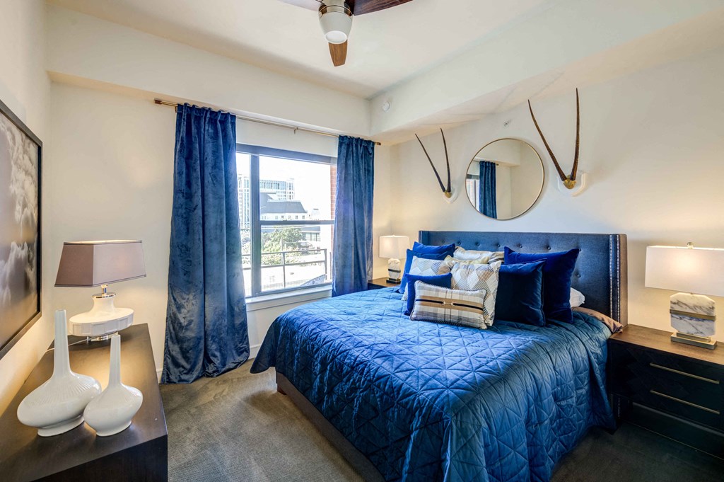 a bedroom with a large bed and a window