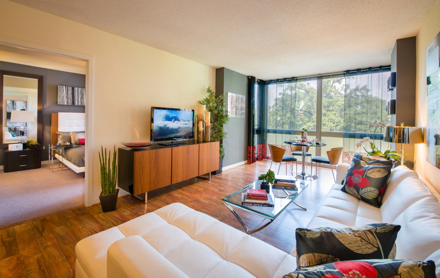 a living room with a white couch and a television