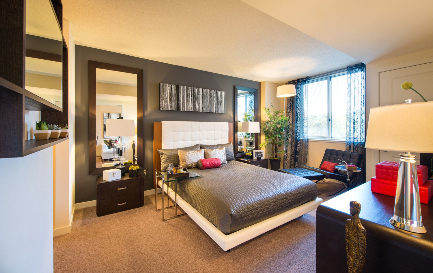 a bedroom with a bed and a desk and a living room