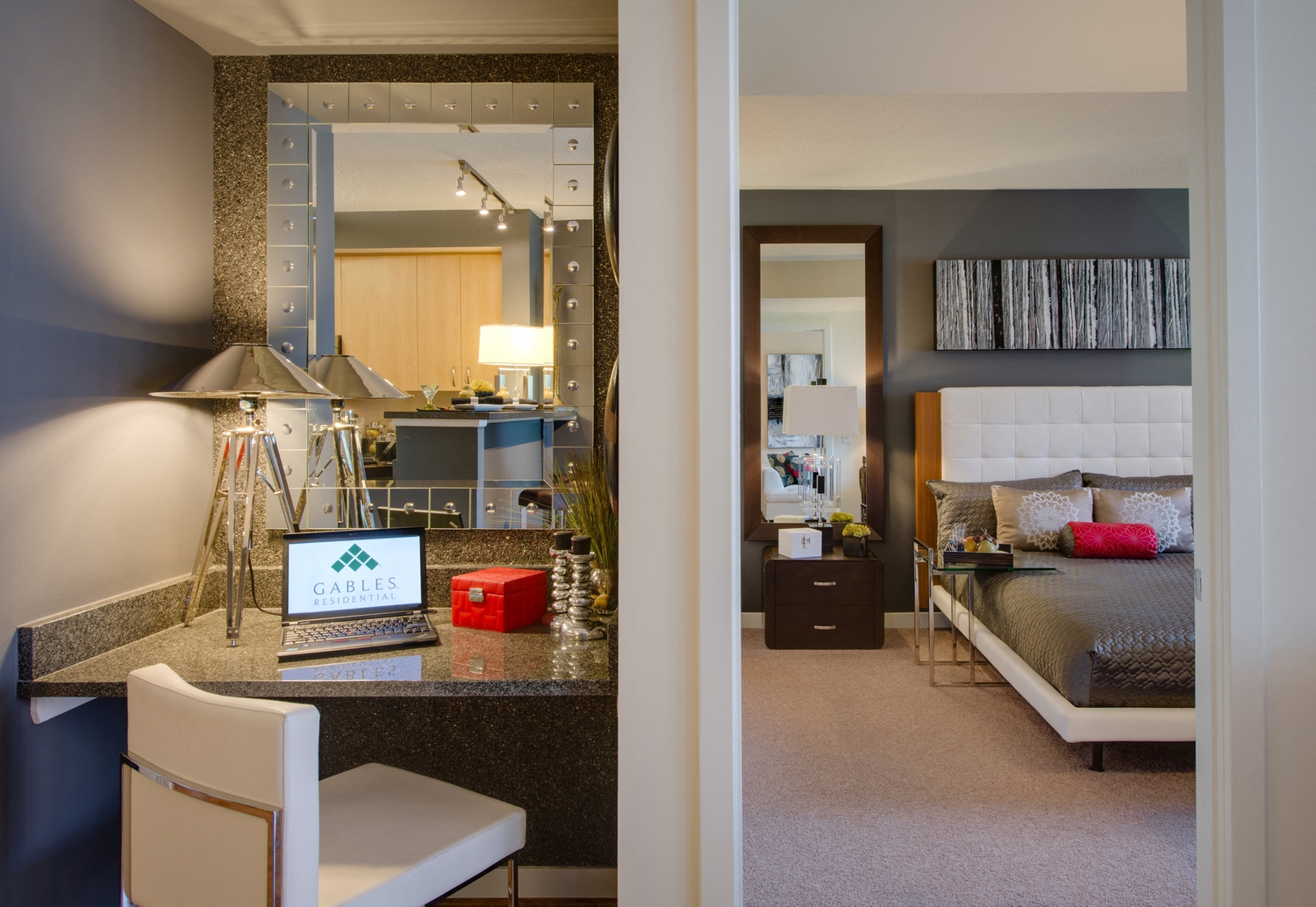 a bedroom and a living room with a bed and a desk