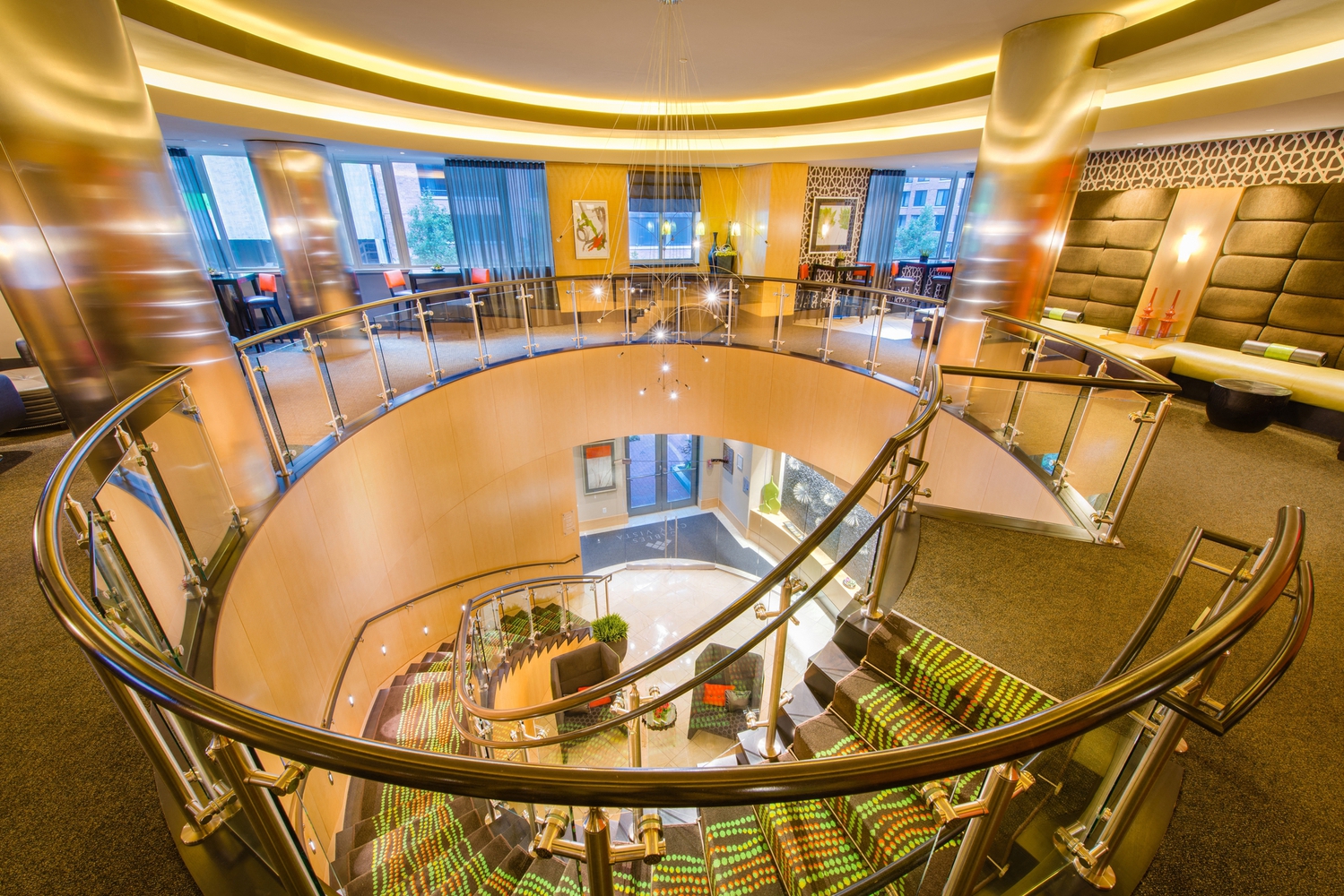 the lobby or reception area of a hotel with a large spiral staircase