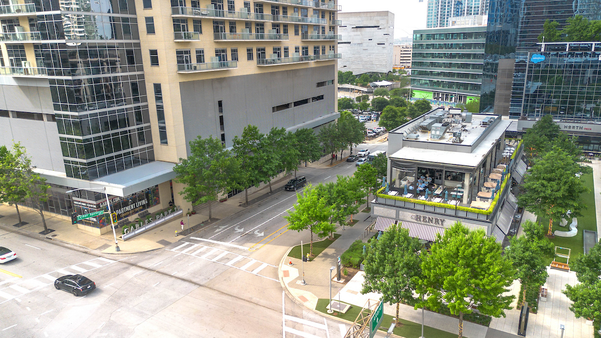 A view of a city street with a building in the background.