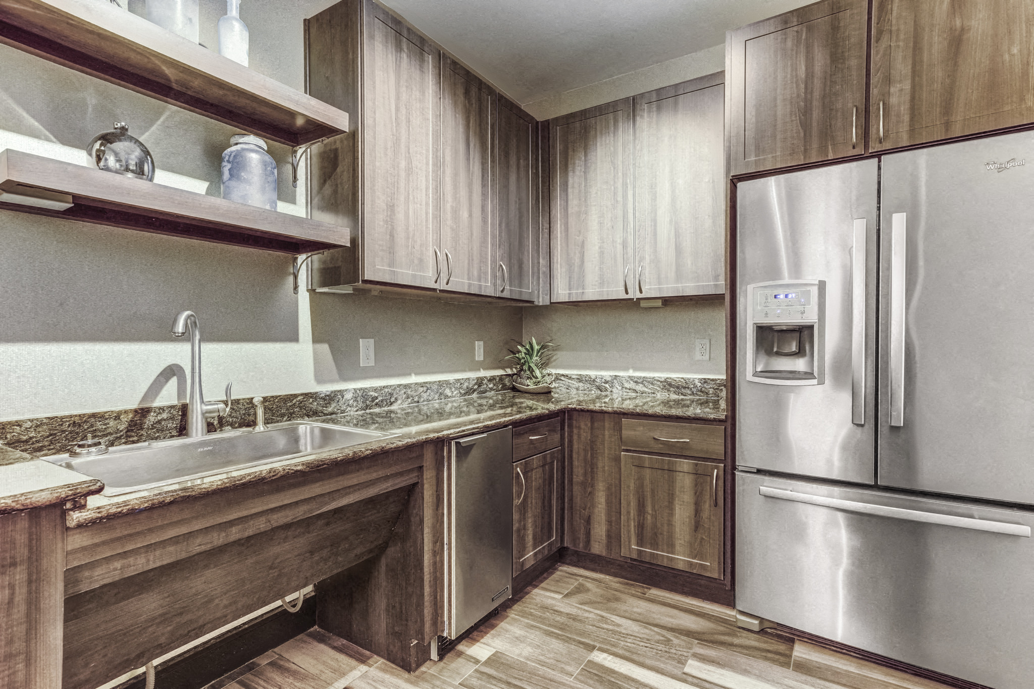a kitchen with wooden cabinets and stainless steel appliances