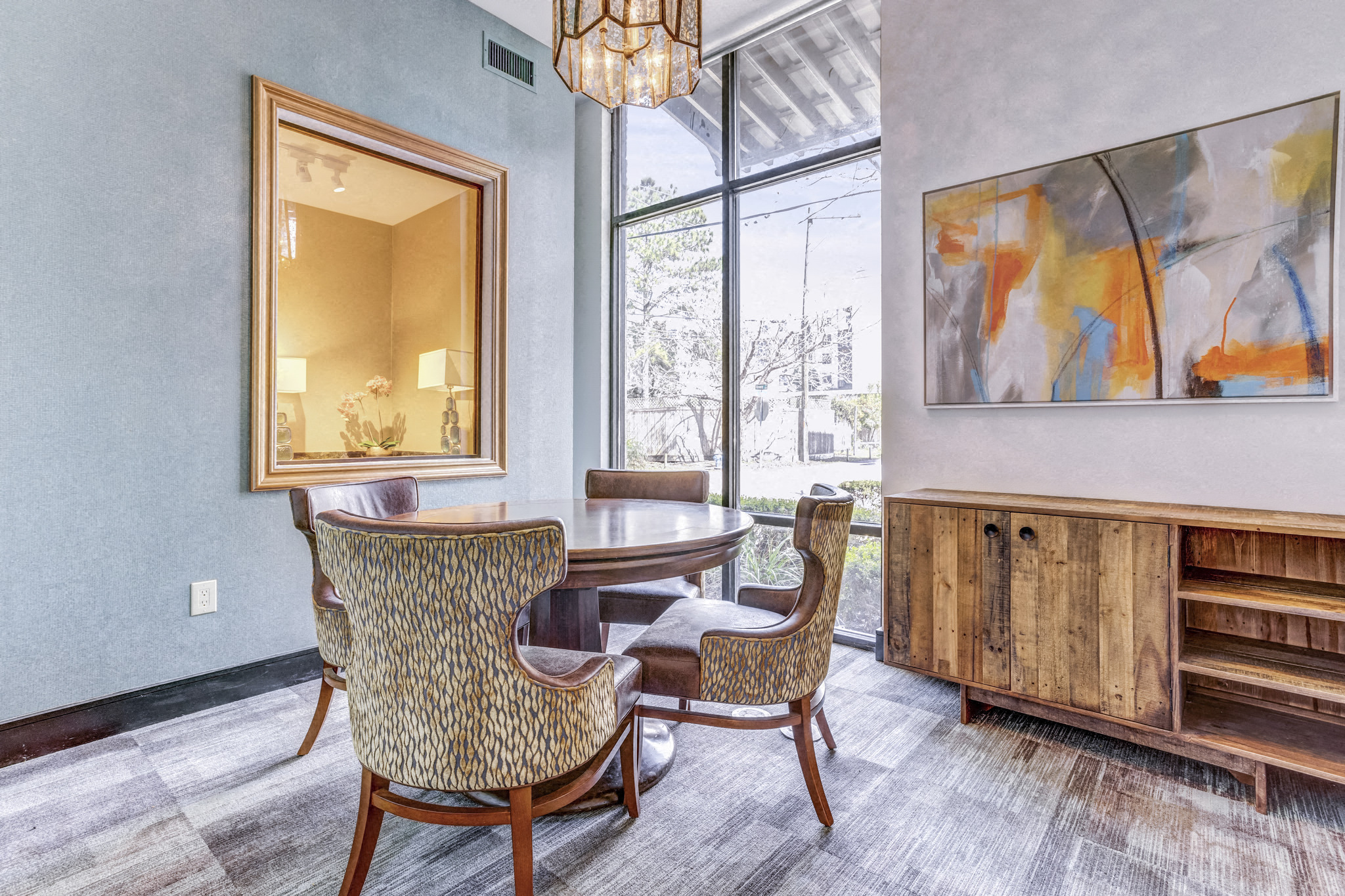 a dining room with a table and chairs and a large window