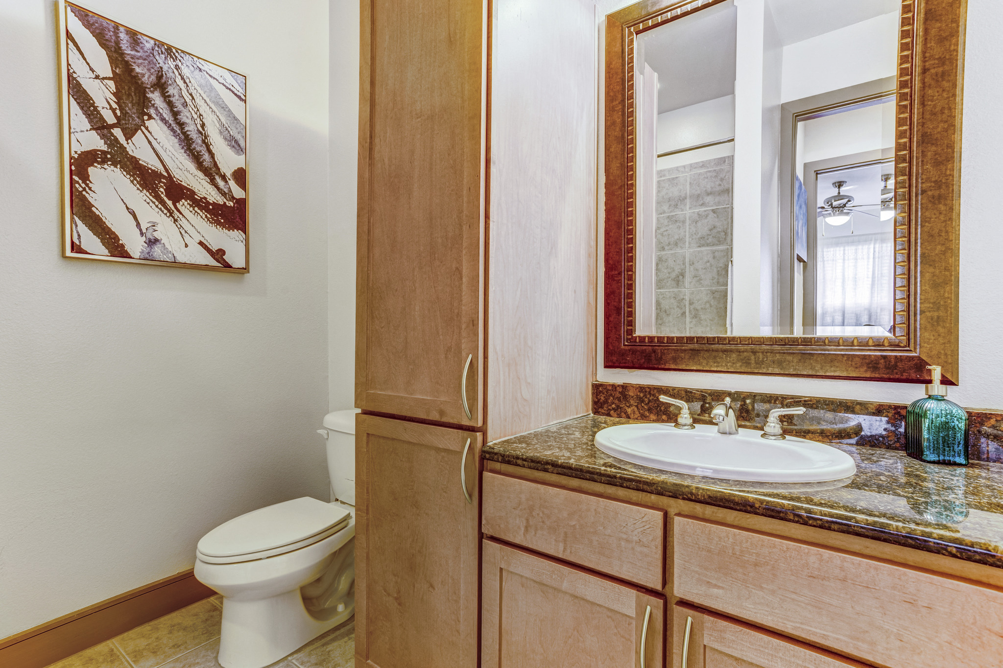 a bathroom with a sink and a toilet and a mirror
