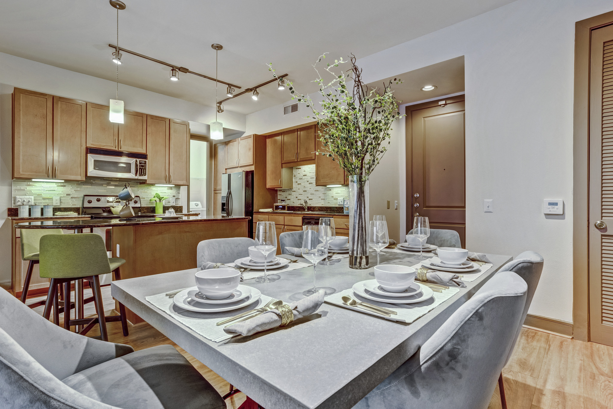 an open kitchen and dining room with a table and chairs