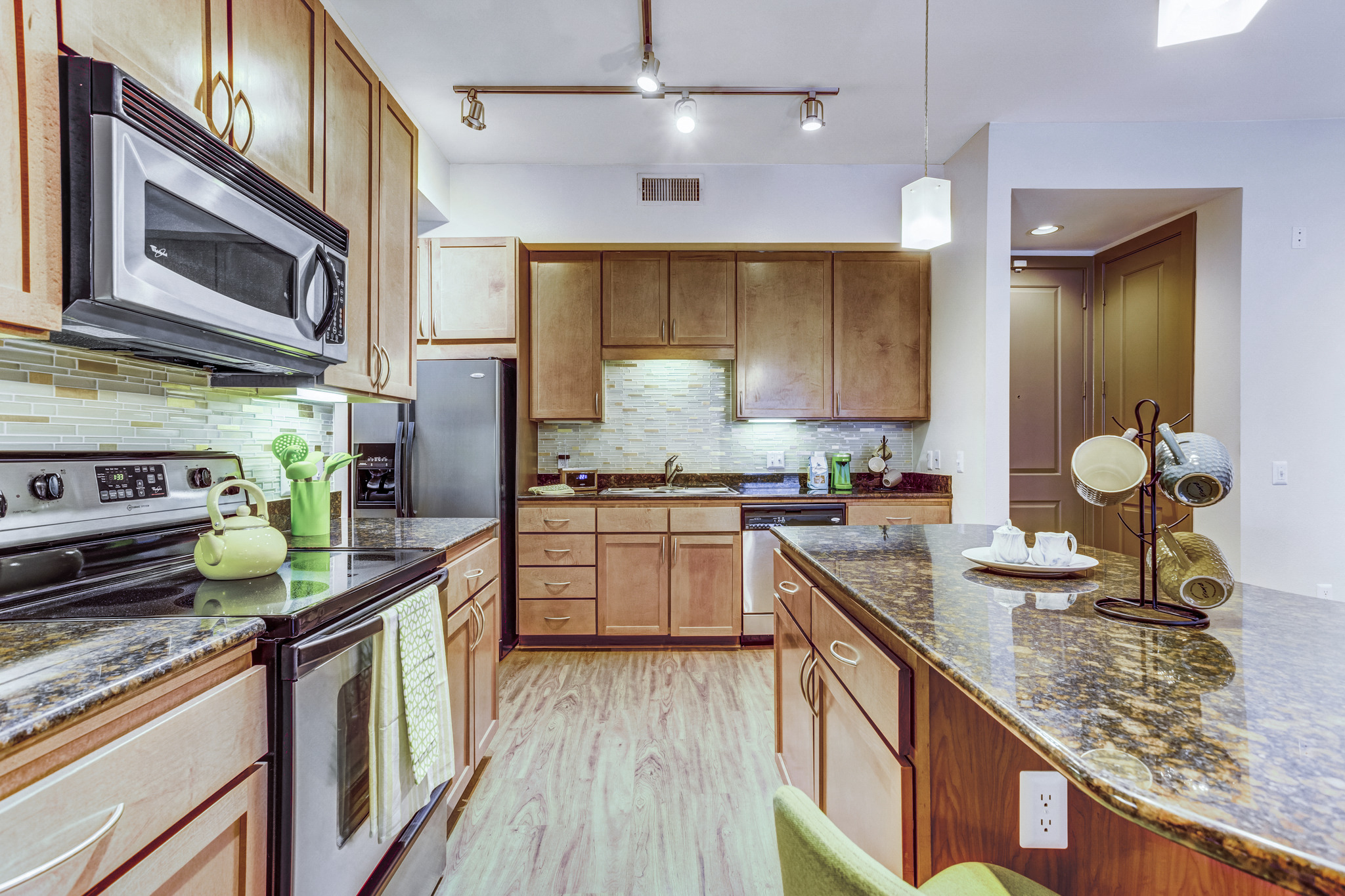 a kitchen with wooden cabinets and granite counter tops