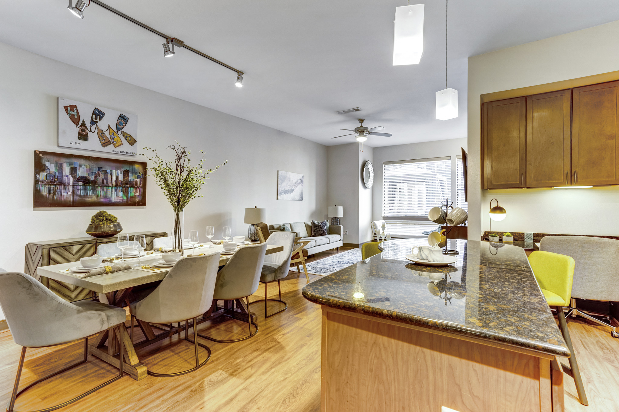 the living room and dining room of a house with a table and chairs