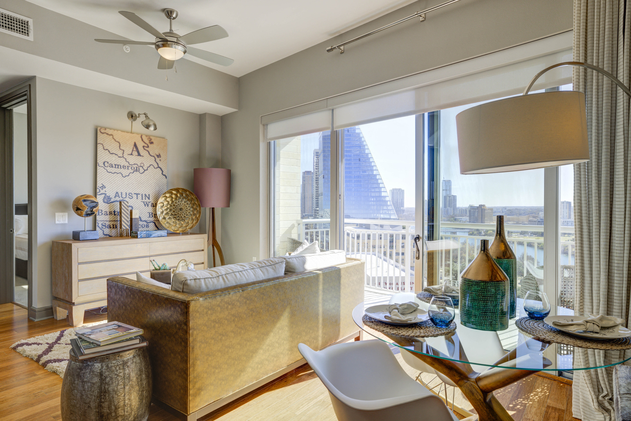 a living room with a large window and a table and chairs