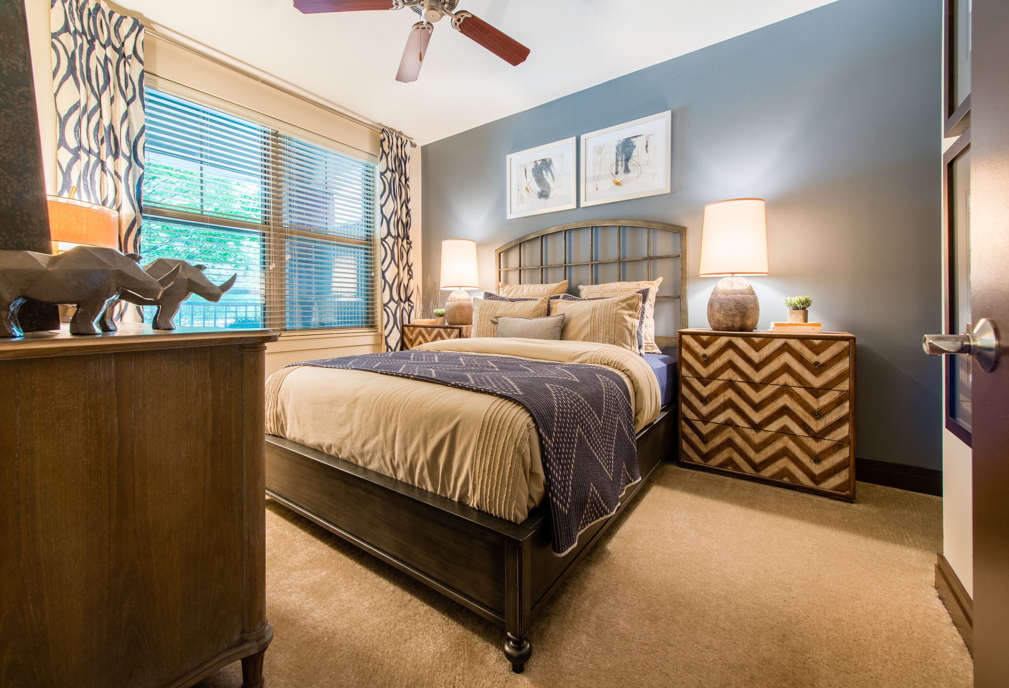 a bedroom with a bed and a dresser and a window