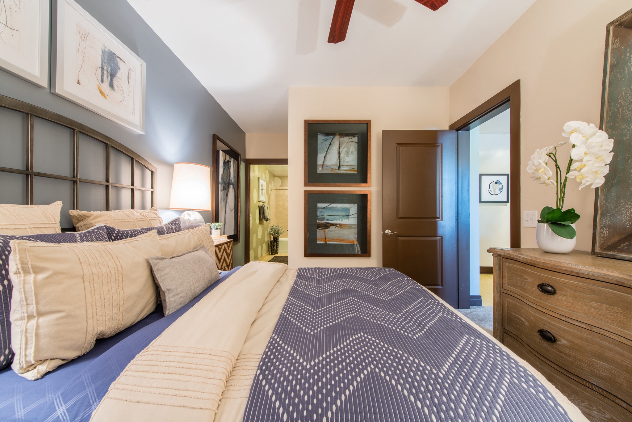 a bedroom with a large bed and a door to a bathroom