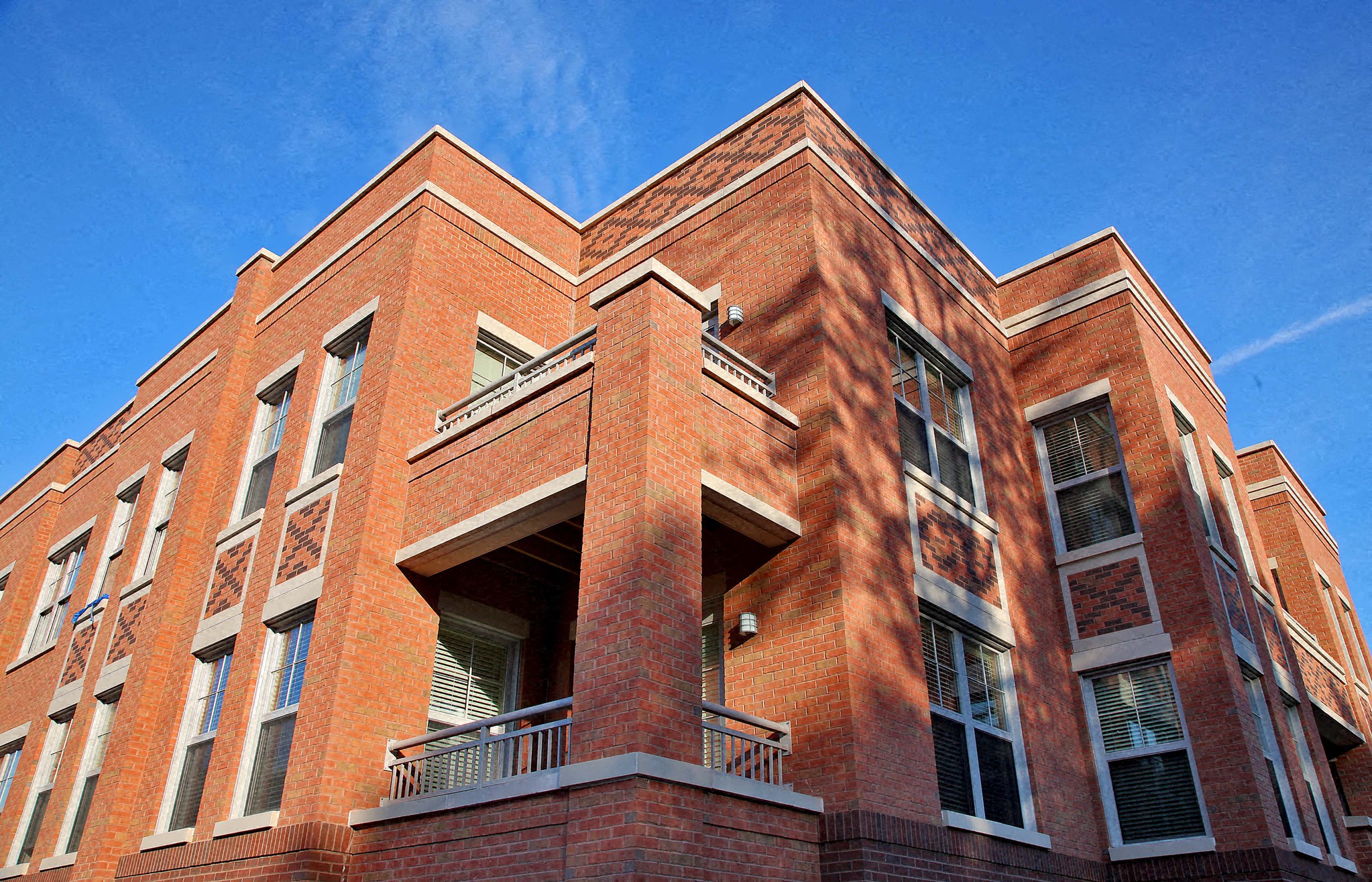 a red brick building against a blue sky