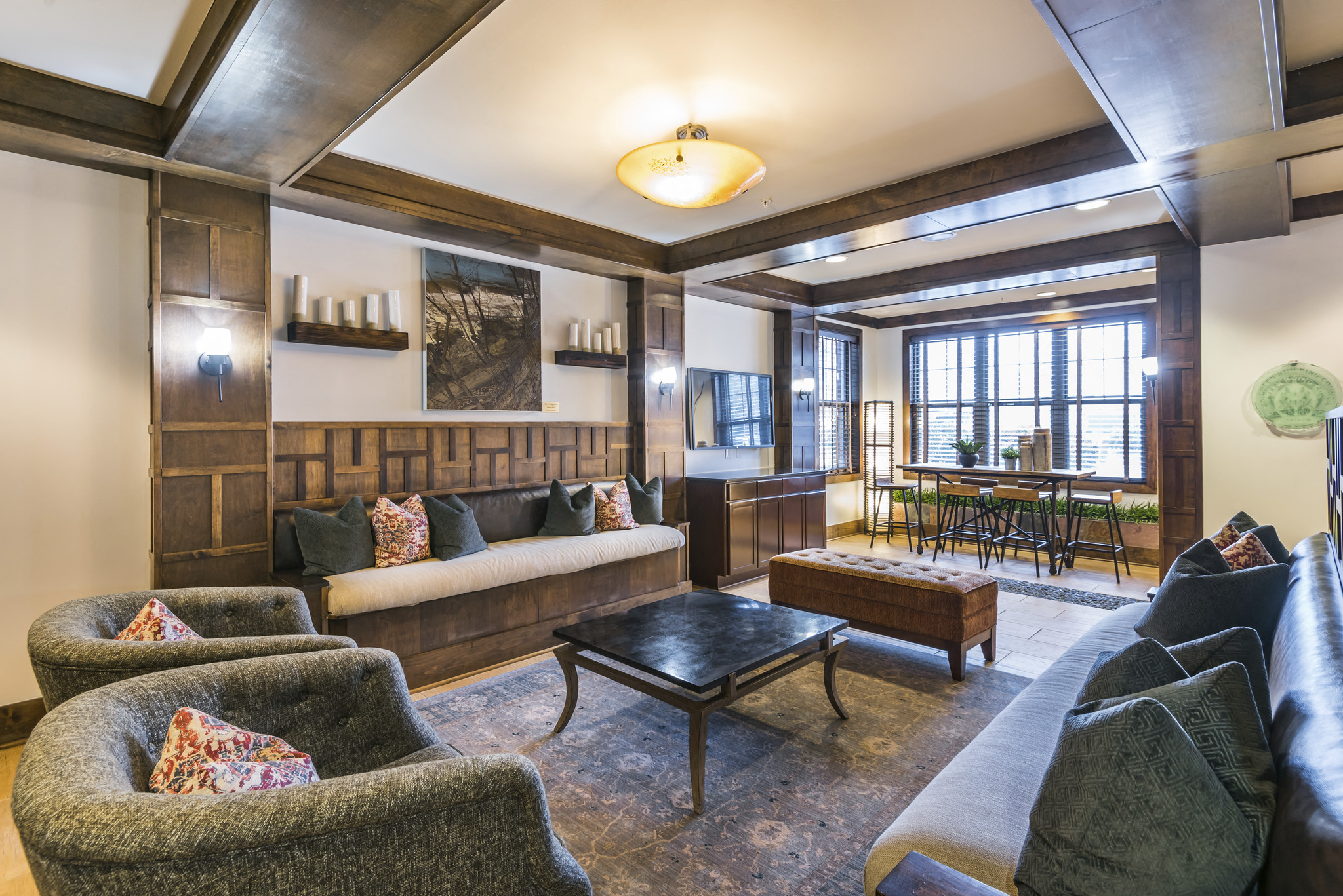 a living room with couches and chairs and a table