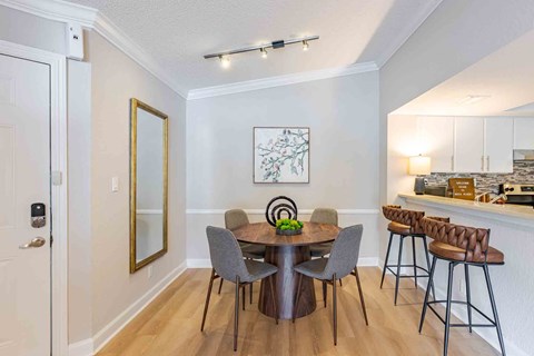 A dining room with a table set for four.