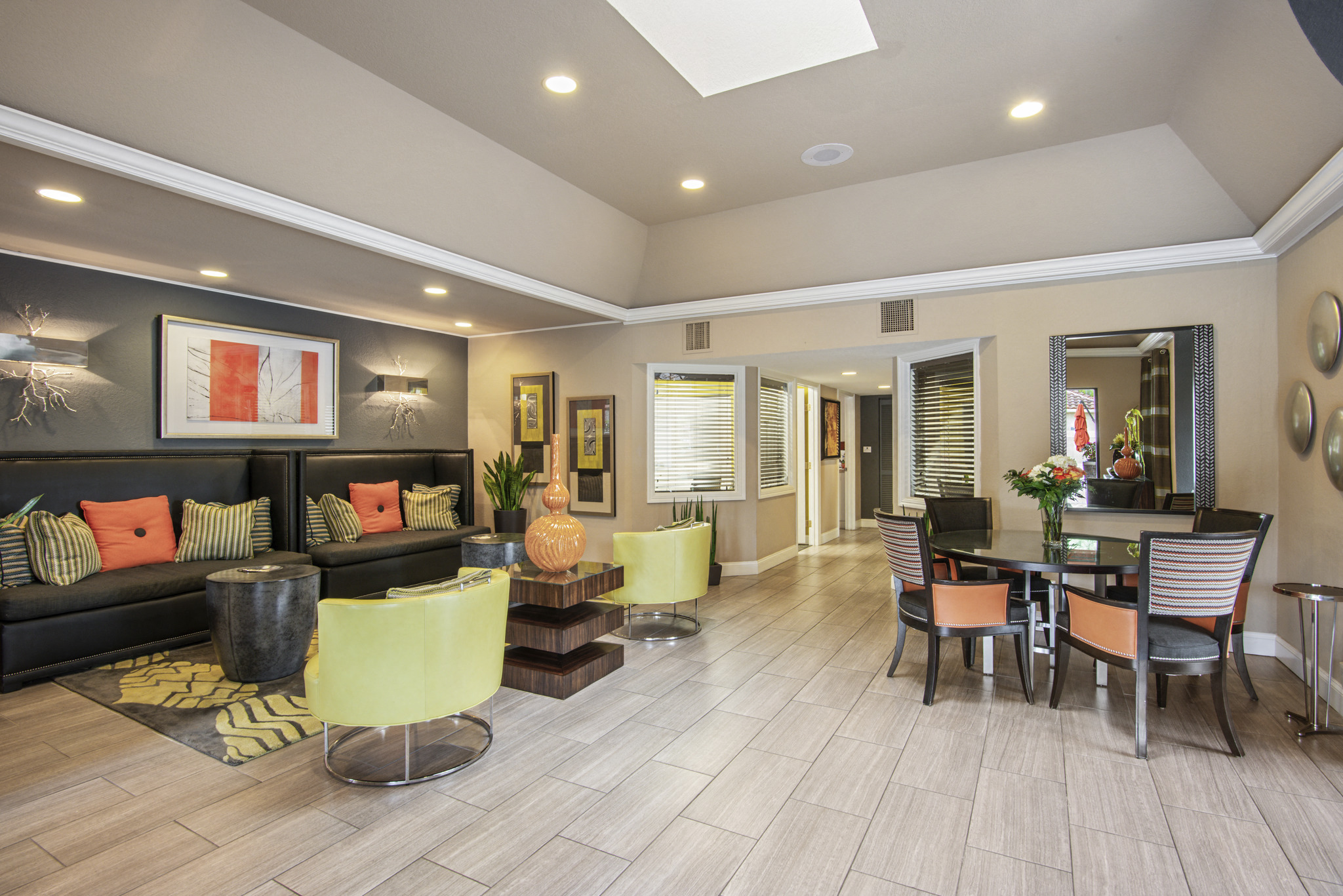 a living room and dining room with yellow chairs and a table