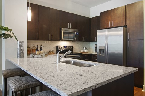 a kitchen with granite counter tops and stainless steel appliances
