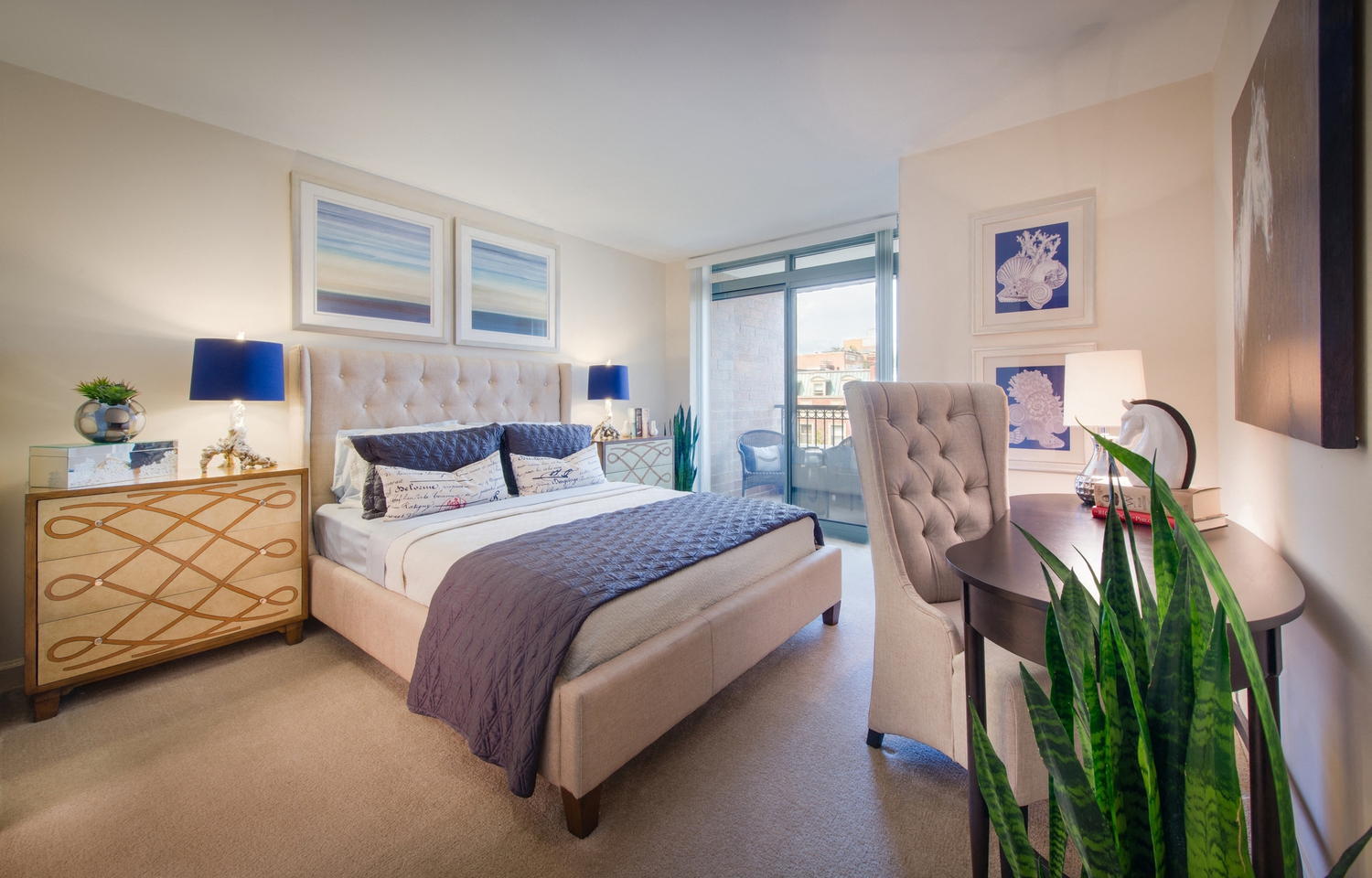 a bedroom with a bed and a desk and a window