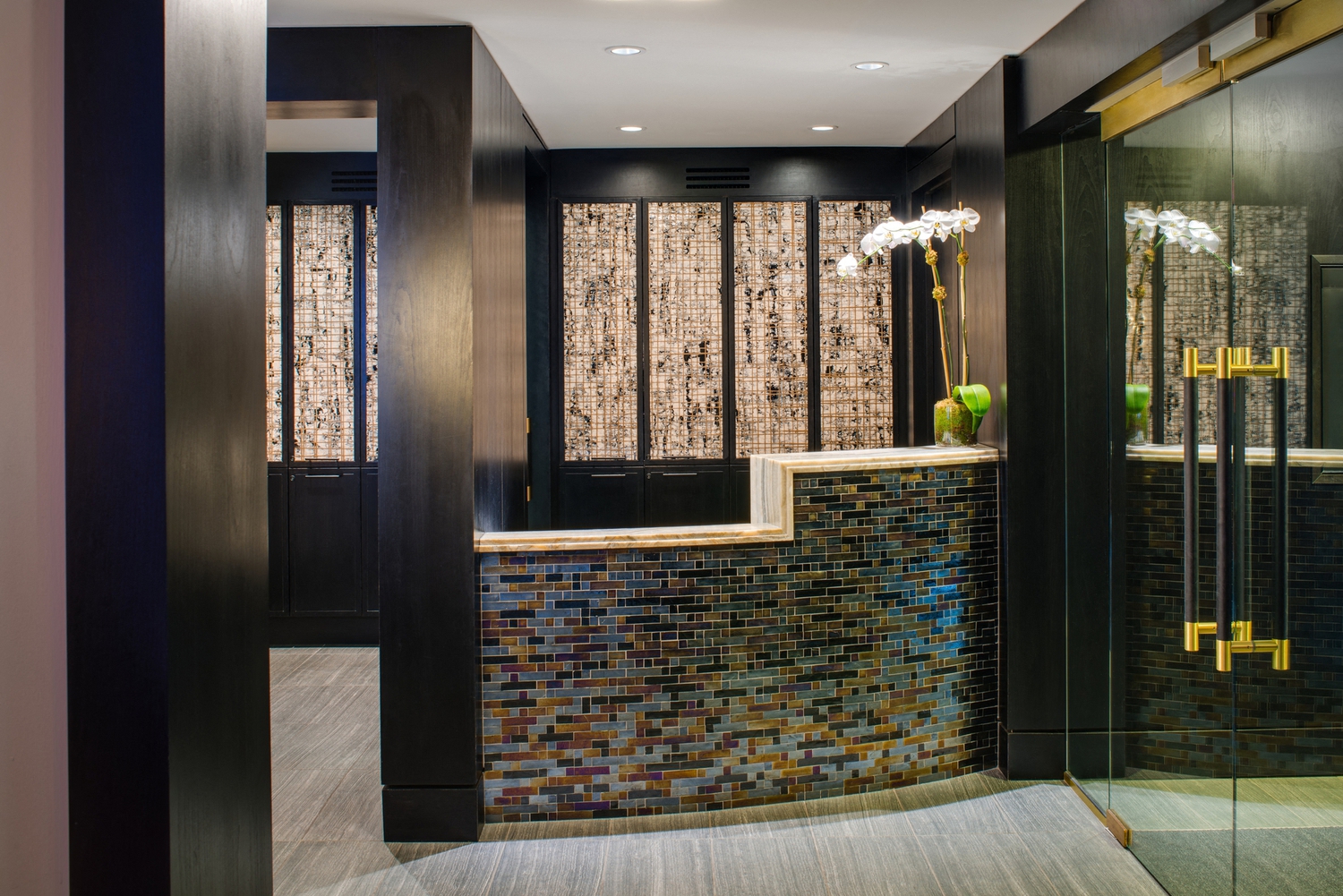 a luxurious bathroom with a large shower and a blue and black tiled wall