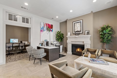A living room with a fireplace and a painting on the wall.