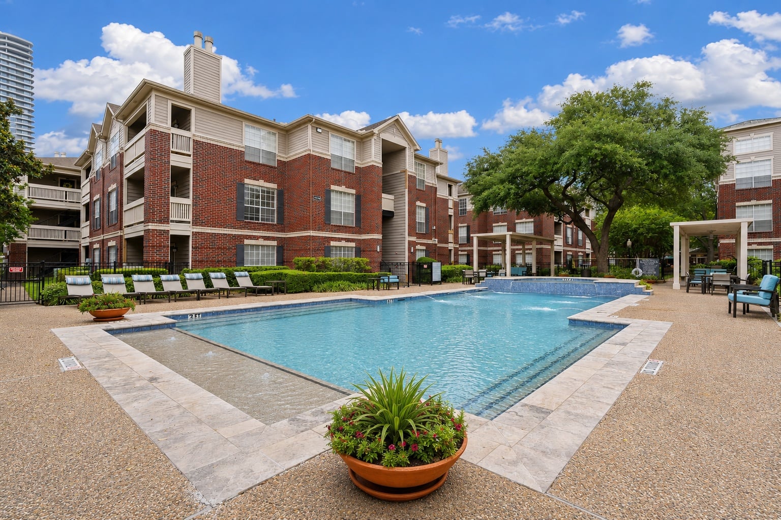 A large pool in front of a red brick building.