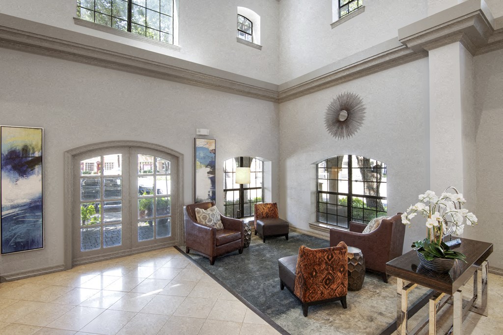 a living room with couches and chairs and a large window