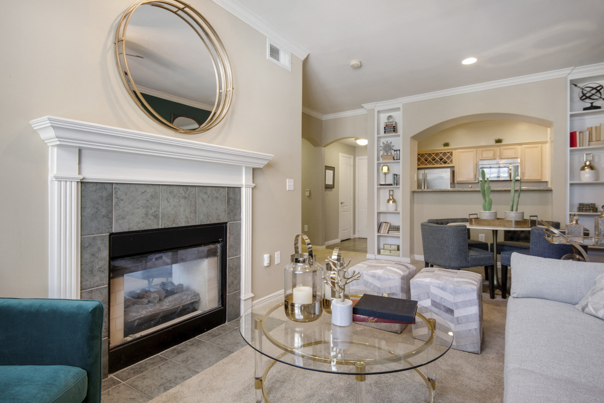 a living room with a fireplace and a glass coffee table