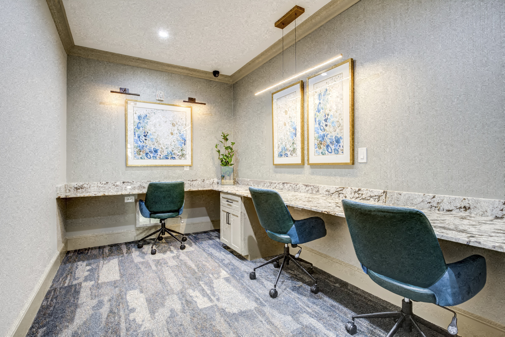 a conference room with three desks and three chairs