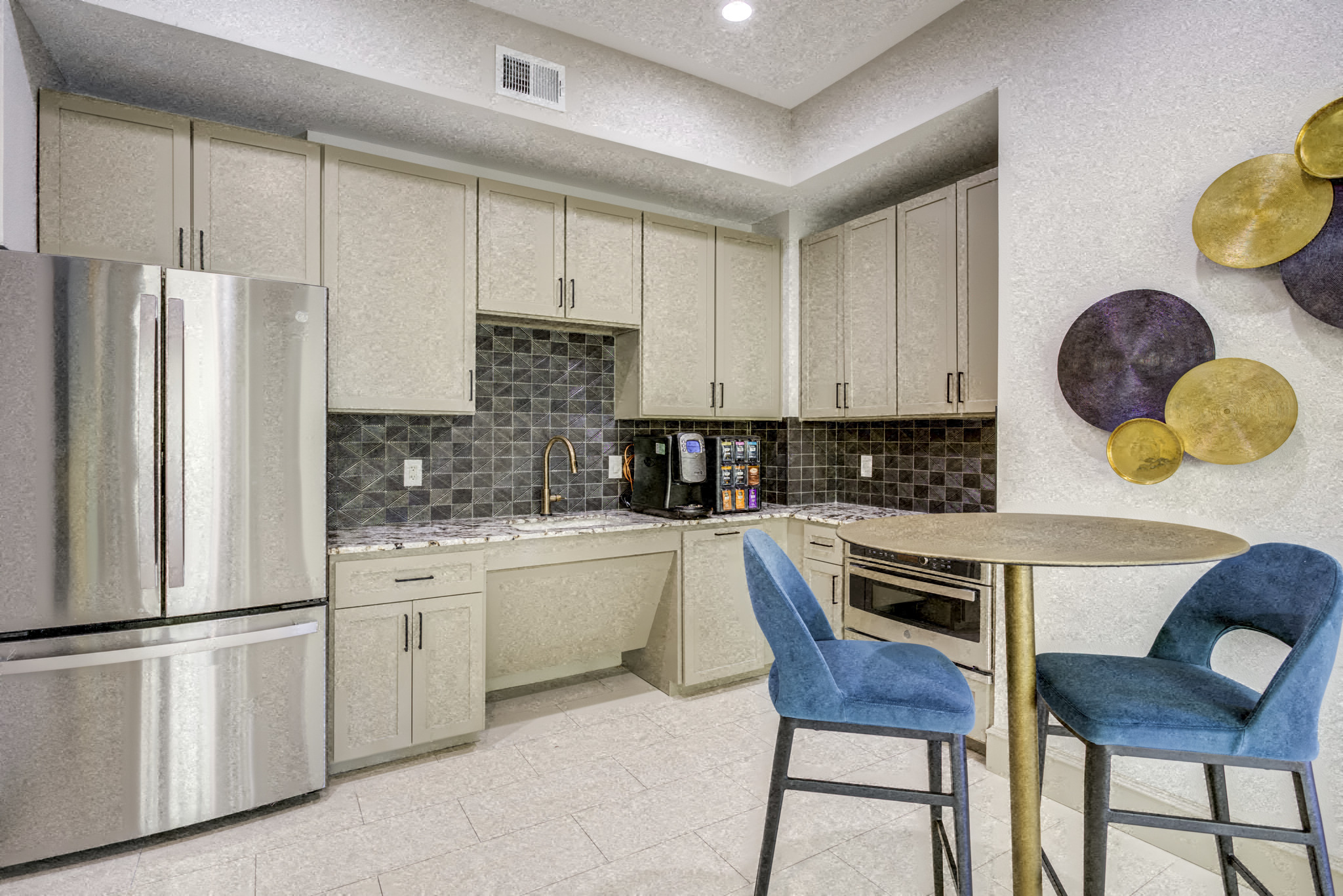 a kitchen with a table and chairs and a refrigerator