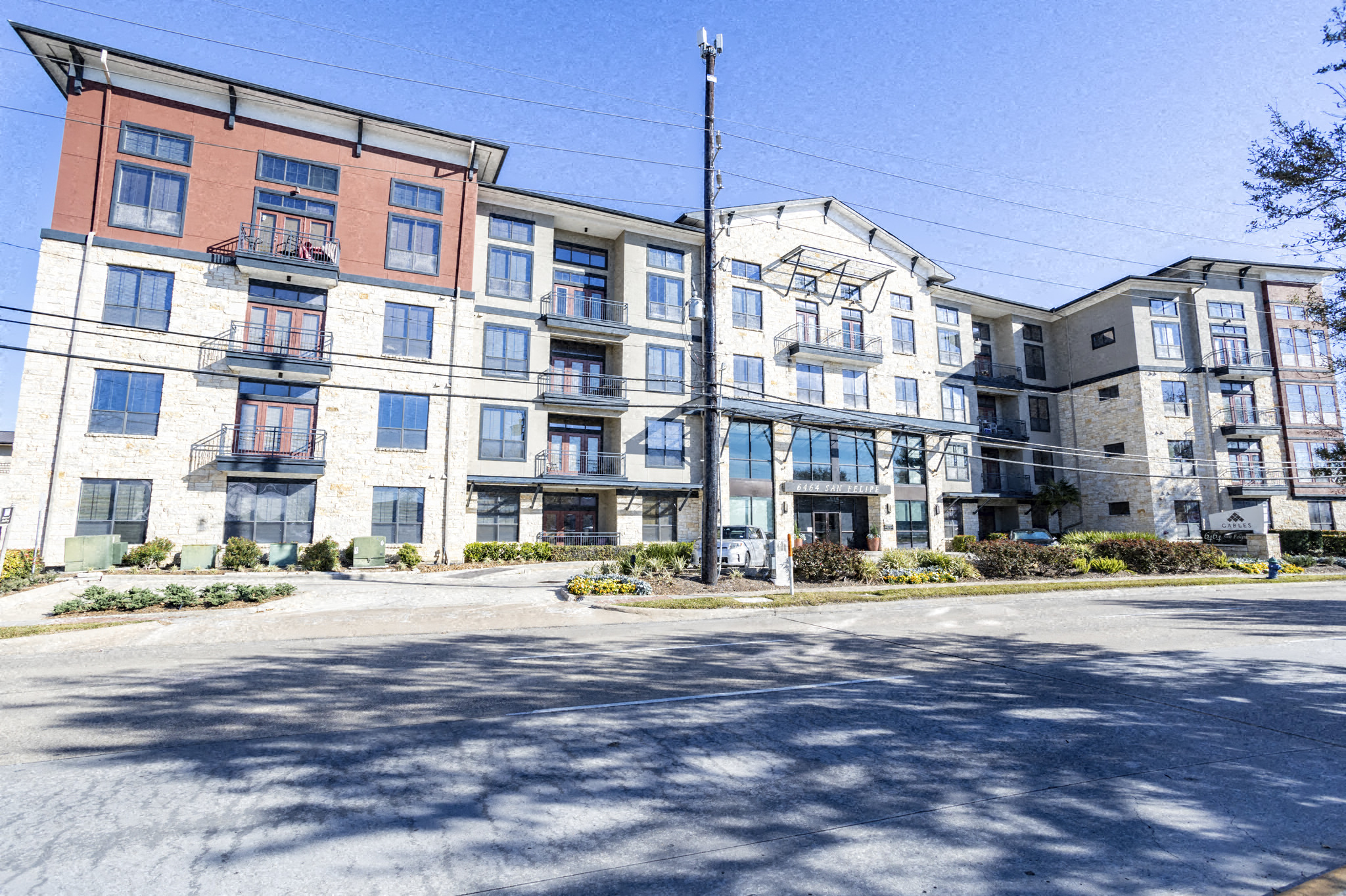 an apartment building with a street in front of it