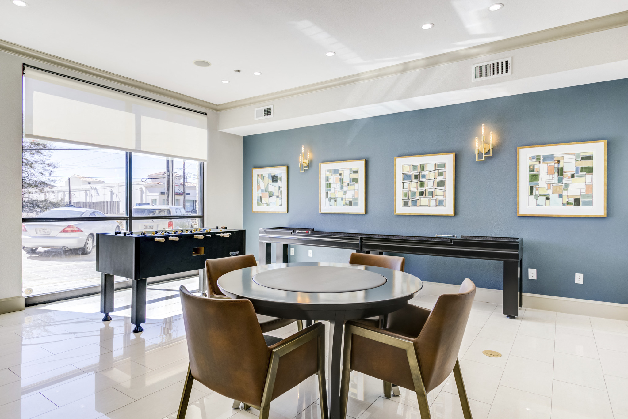 a living room with a table with chairs and a piano