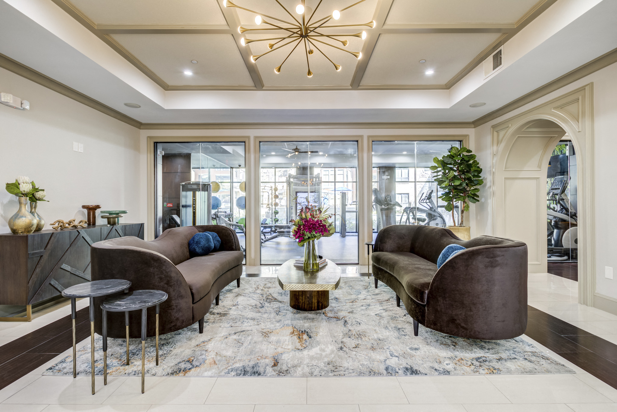 a living room with couches and chairs and a chandelier
