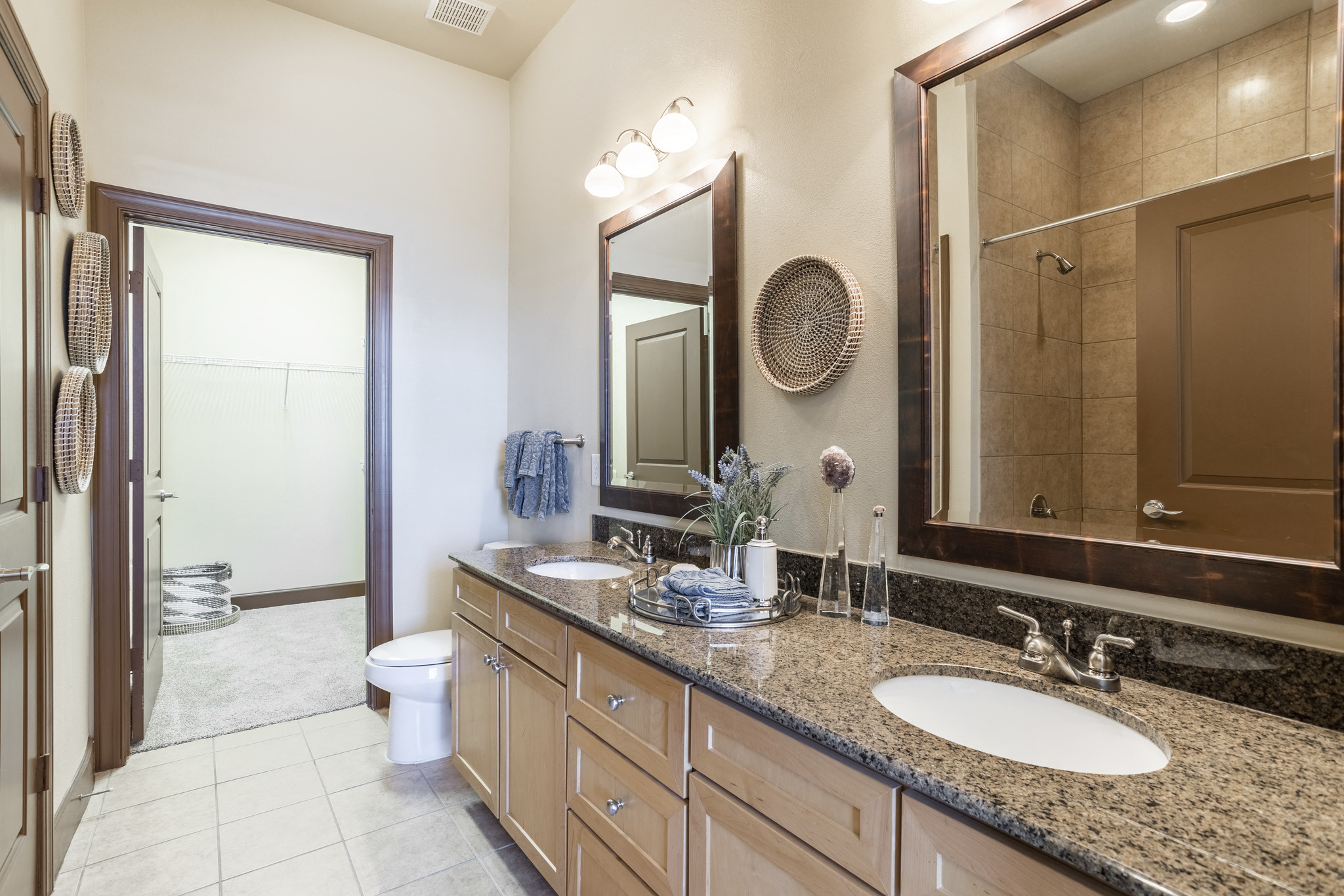 a bathroom with two sinks and a large mirror