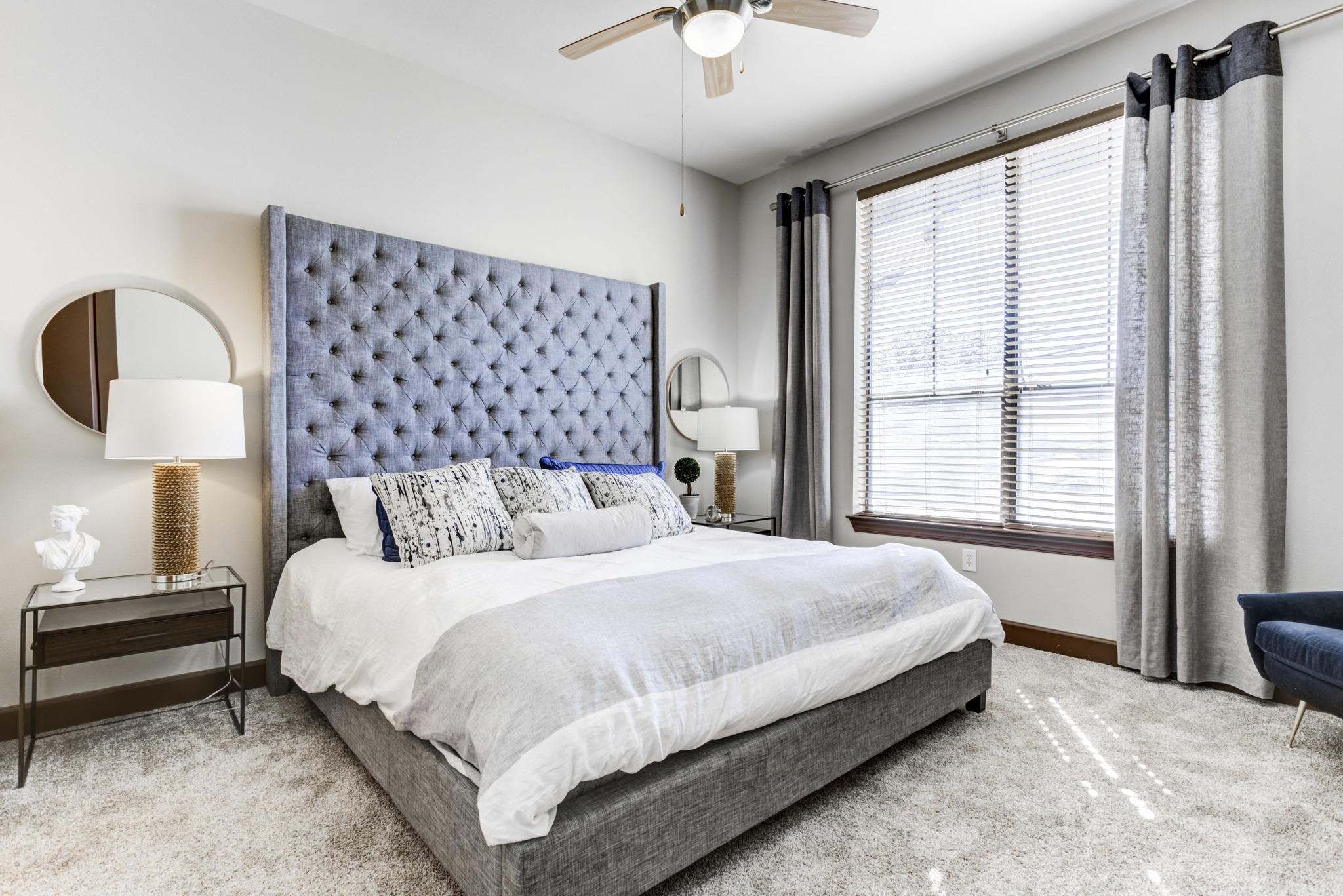 a bedroom with a bed and a ceiling fan