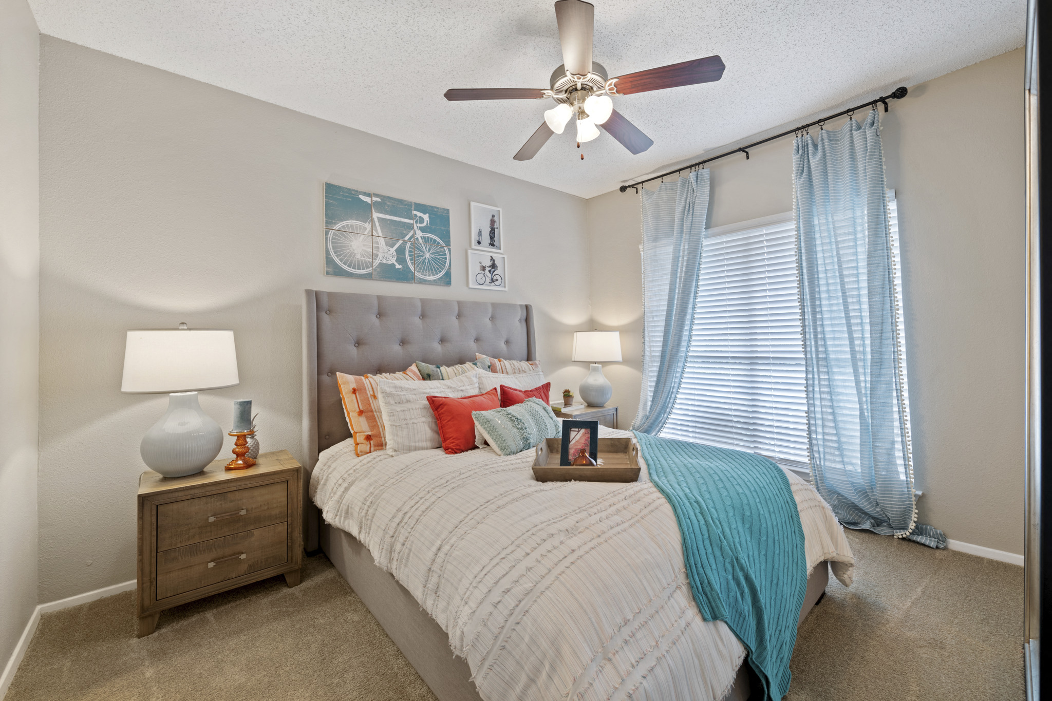 a bedroom with a large bed and a ceiling fan