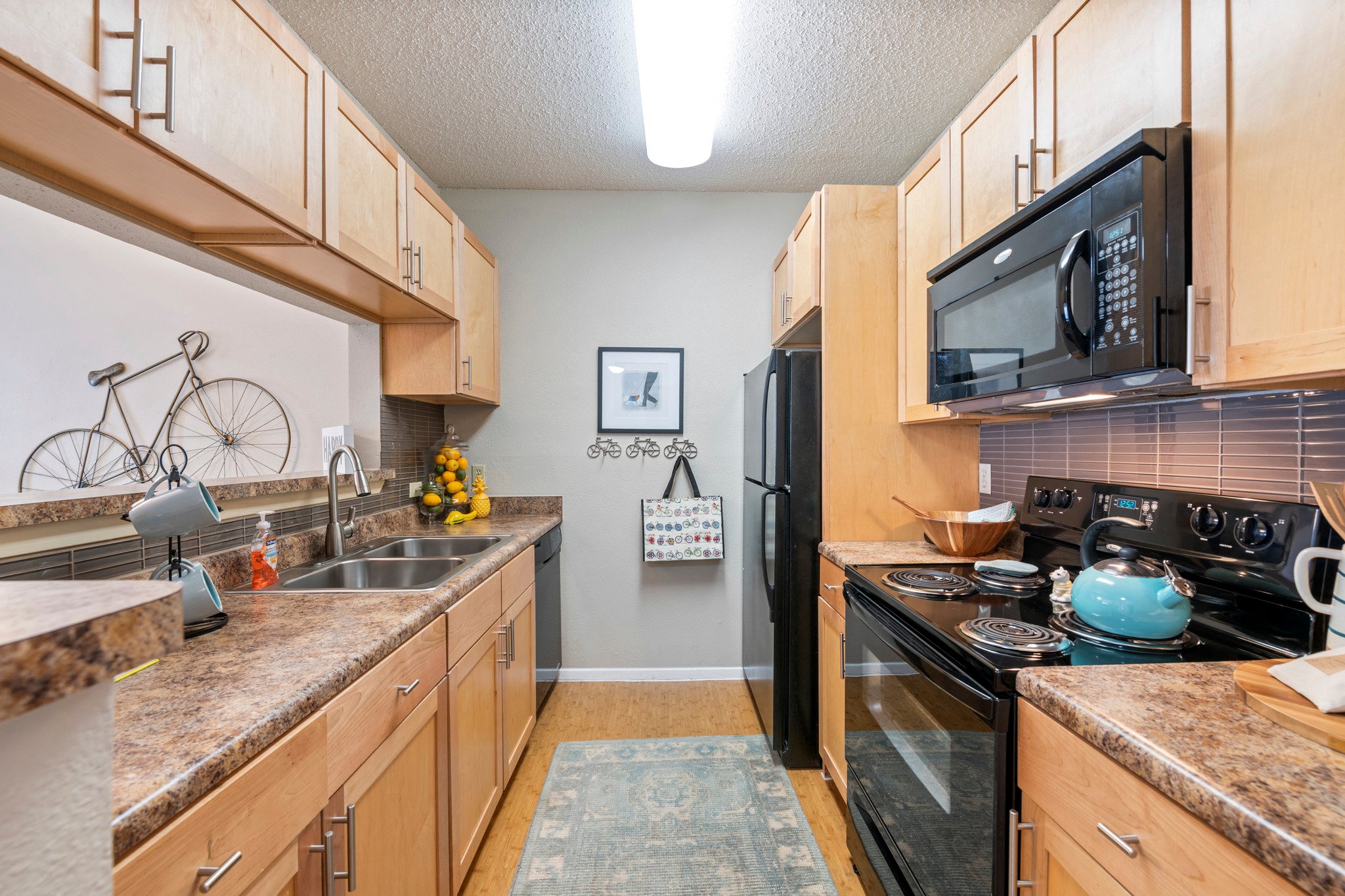 a kitchen with granite counter tops and a black stove and refrigerator