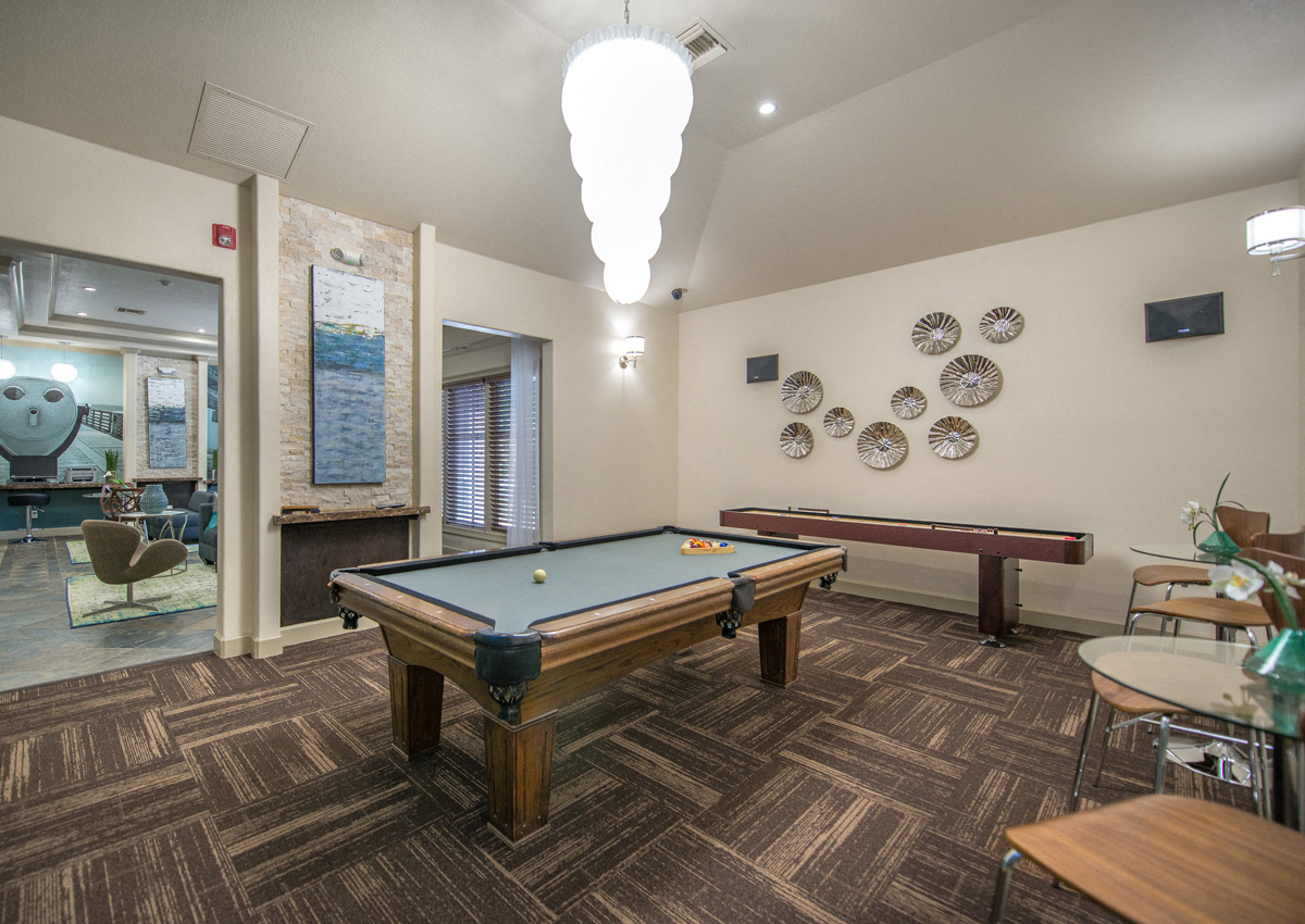 a game room with a pool table and ping pong