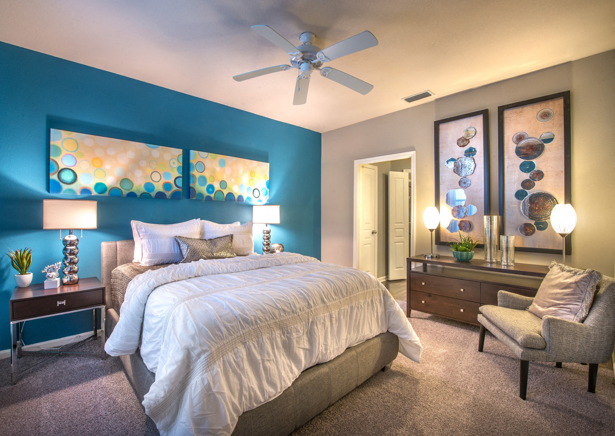 a bedroom with a bed and a ceiling fan