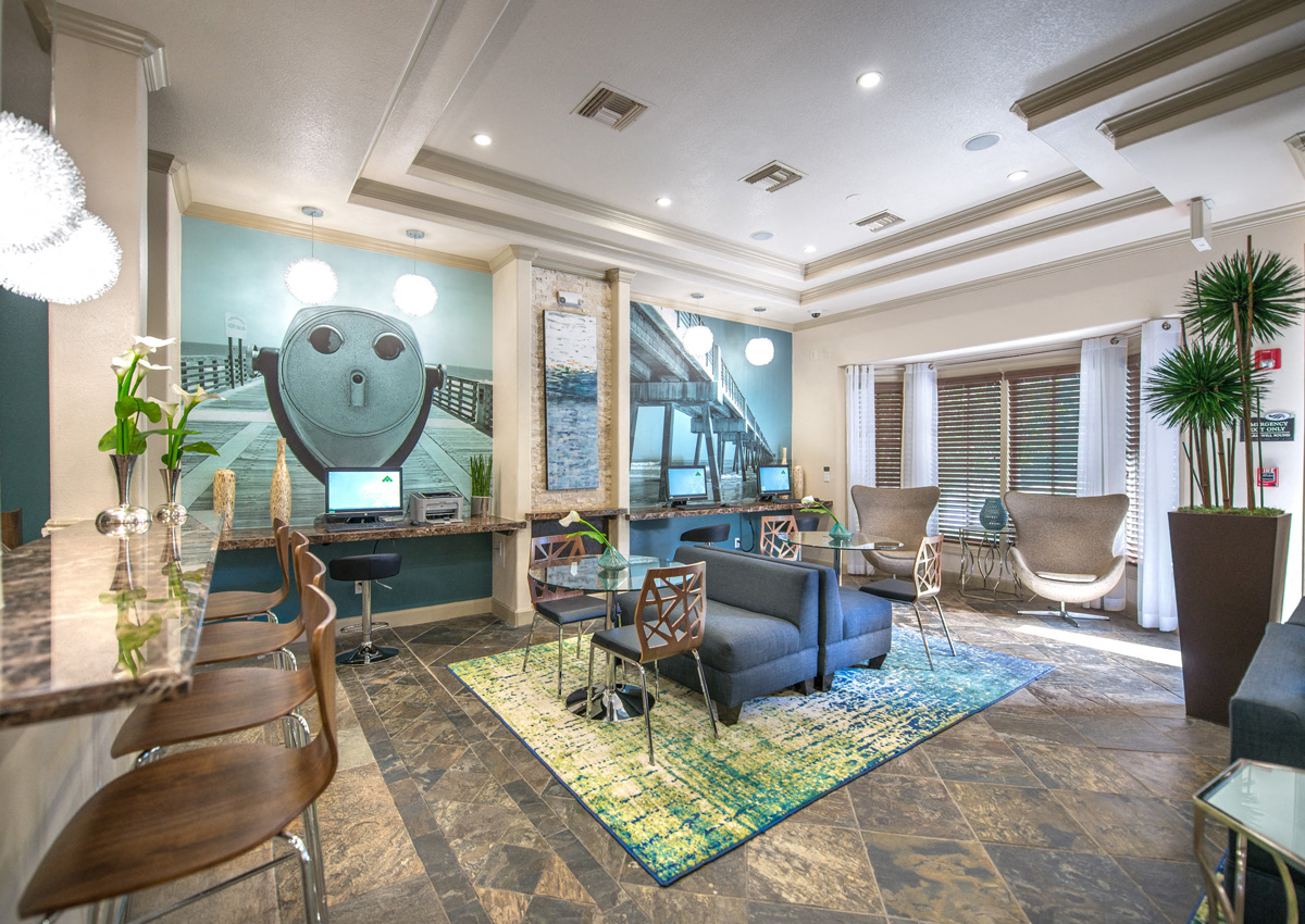 a living room with a blue couch and a table with chairs
