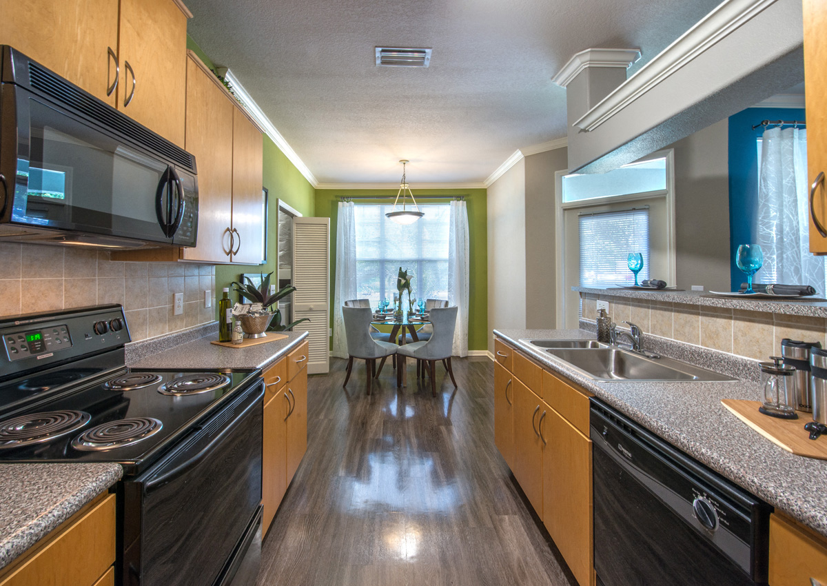 a kitchen with granite counter tops and a dining room table