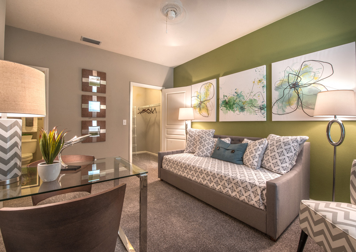 a living room with green walls and a couch