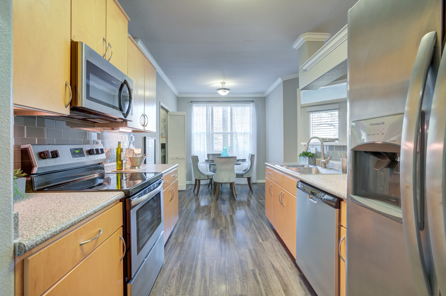 A kitchen with wooden cabinets and stainless steel appliances.