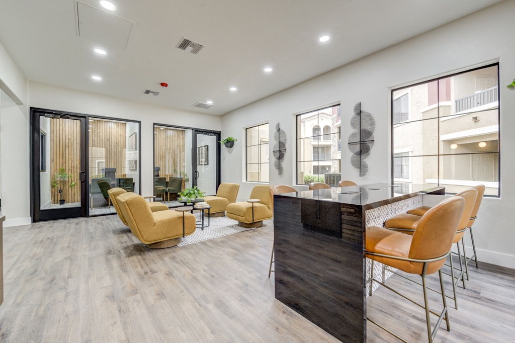 the preserve at ballantyne commons community clubhouse with seating and a bar and windows