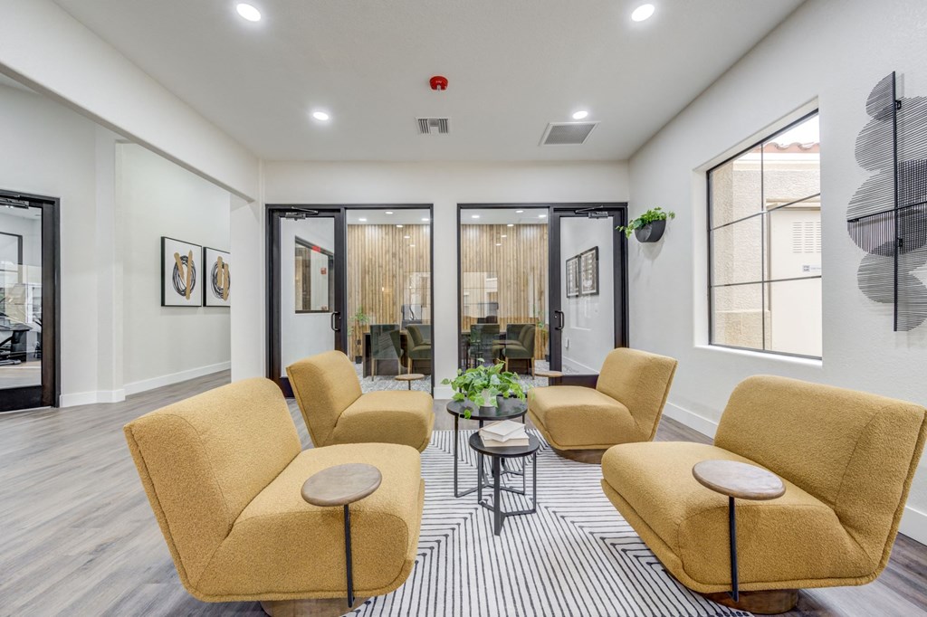 a living room with couches and chairs and sliding glass doors