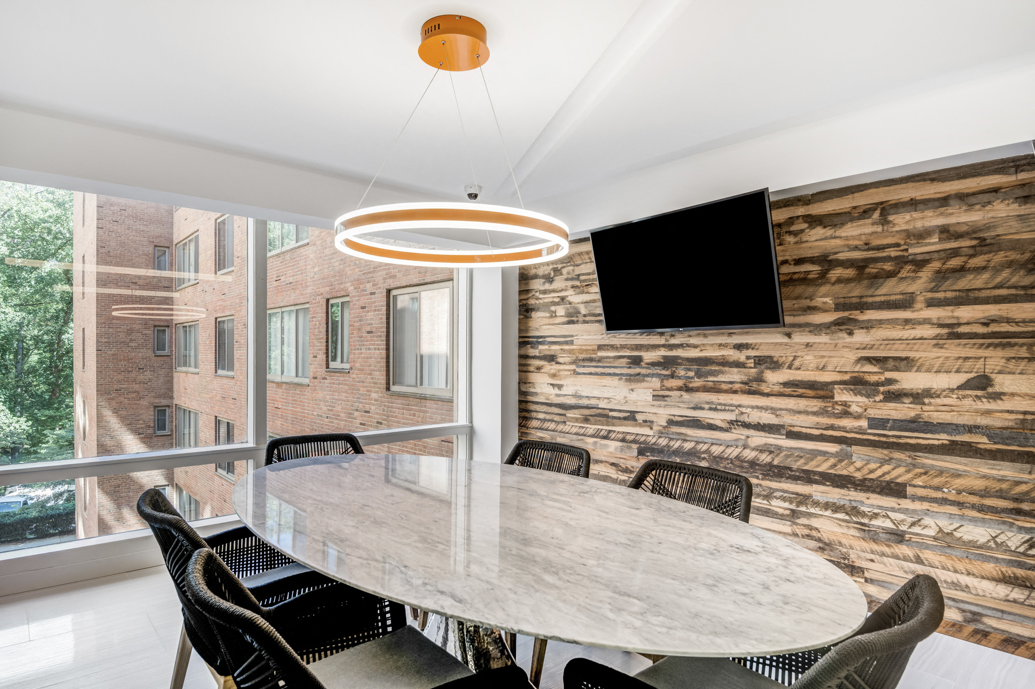 a dining room with a table and chairs and a large window