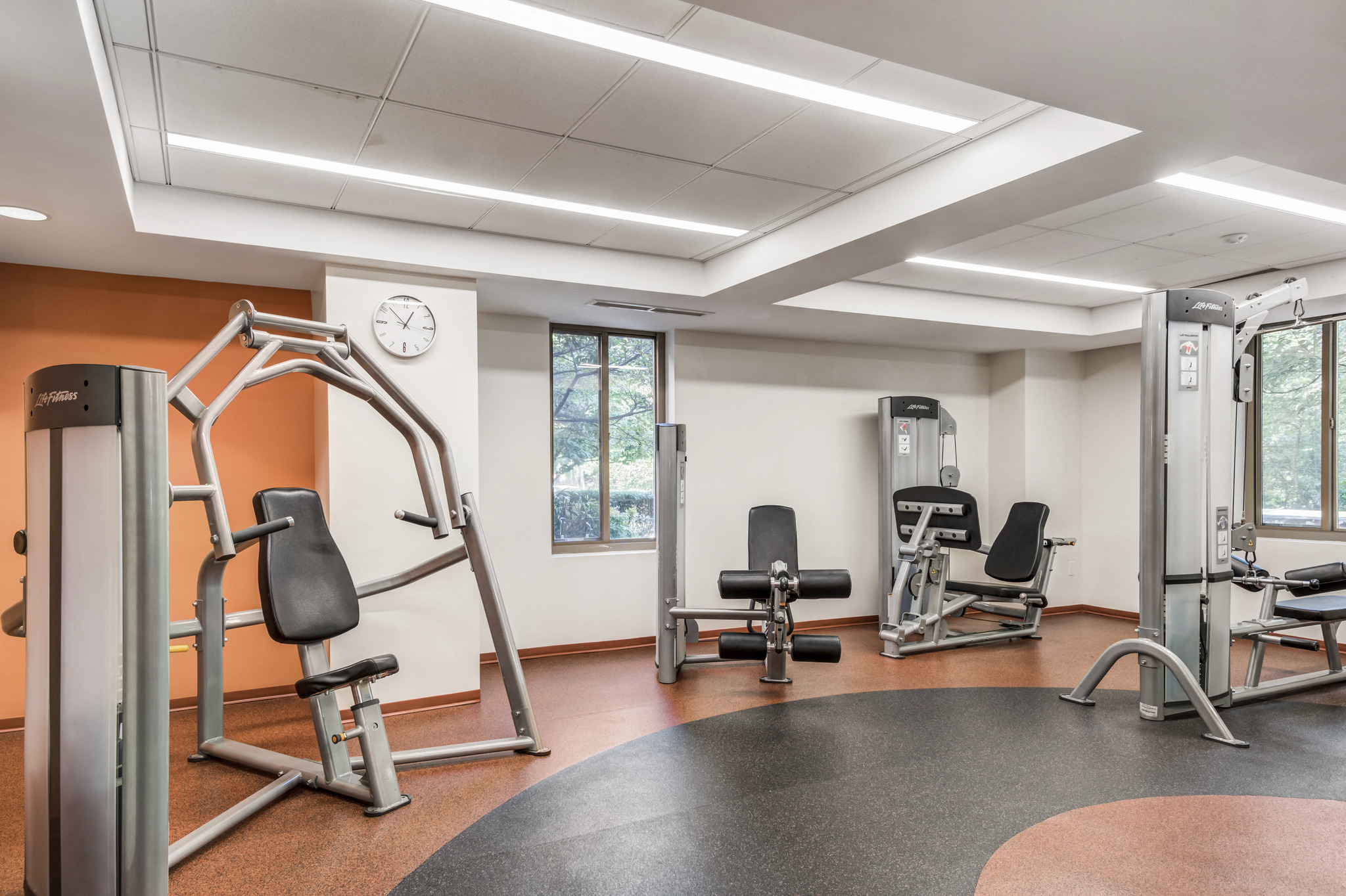 a gym with exercise equipment and chairs in a patient room