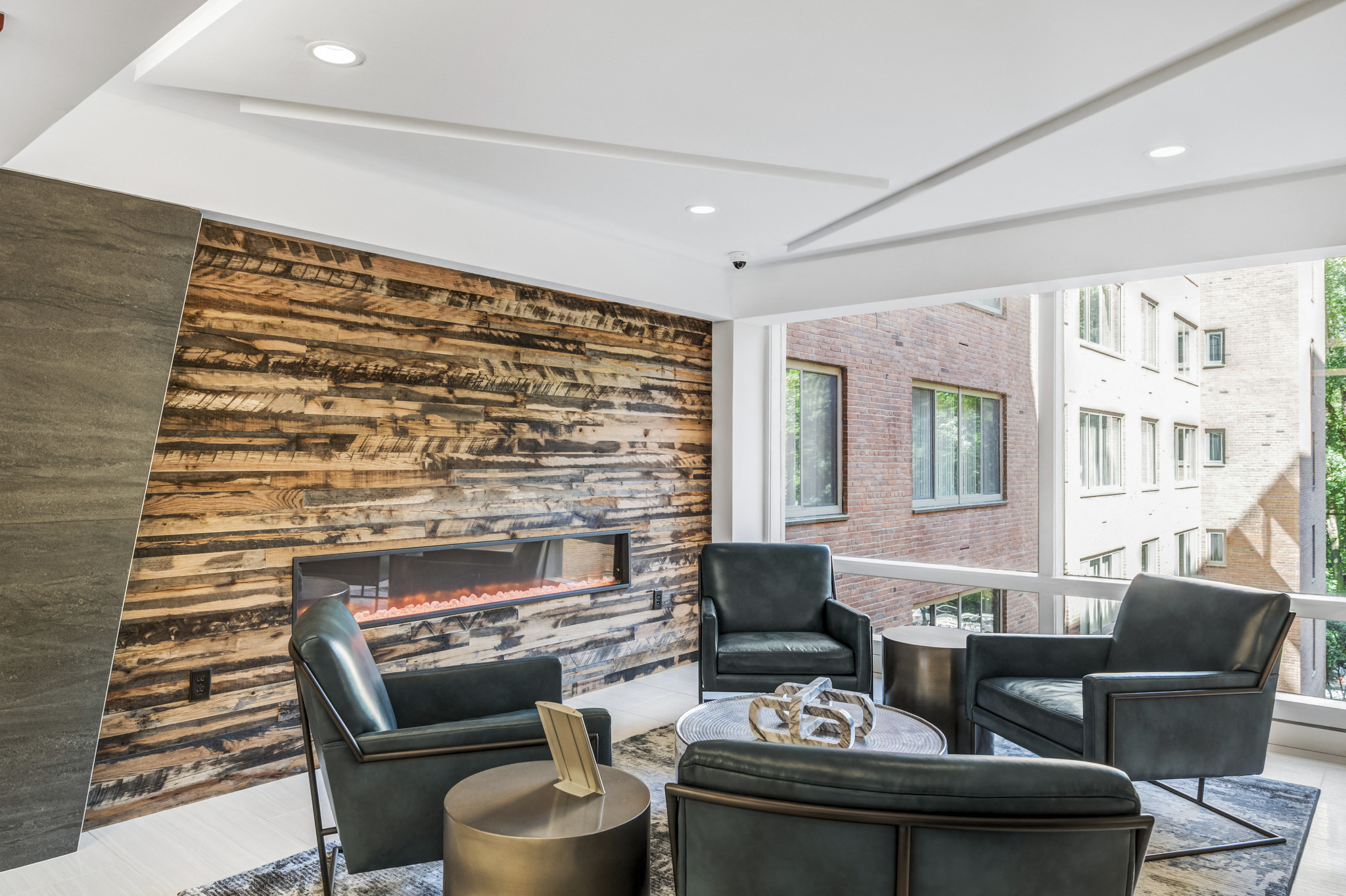 a living room with leather chairs and a fireplace