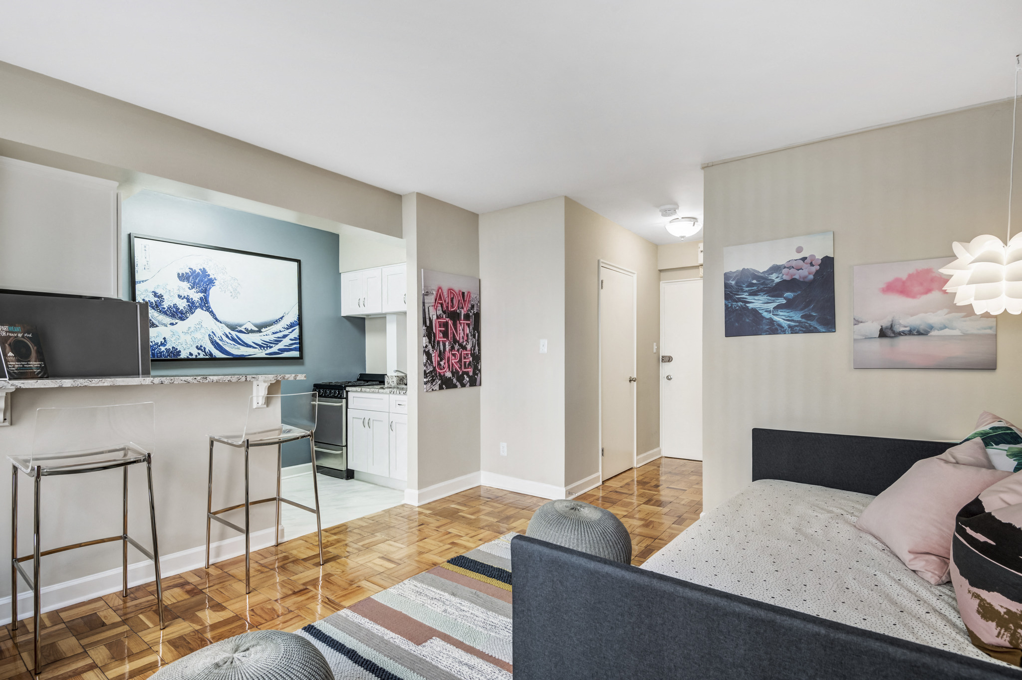 a living room with a couch and a tv and a kitchen