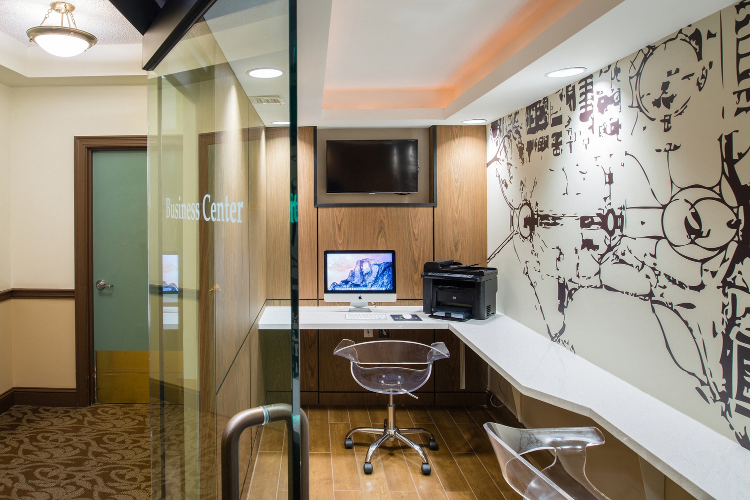 a conference room with a desk and a tv in it