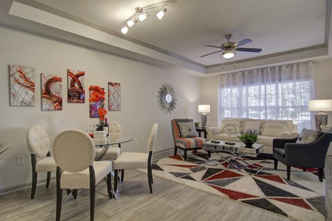 an open living room and dining room with a ceiling fan