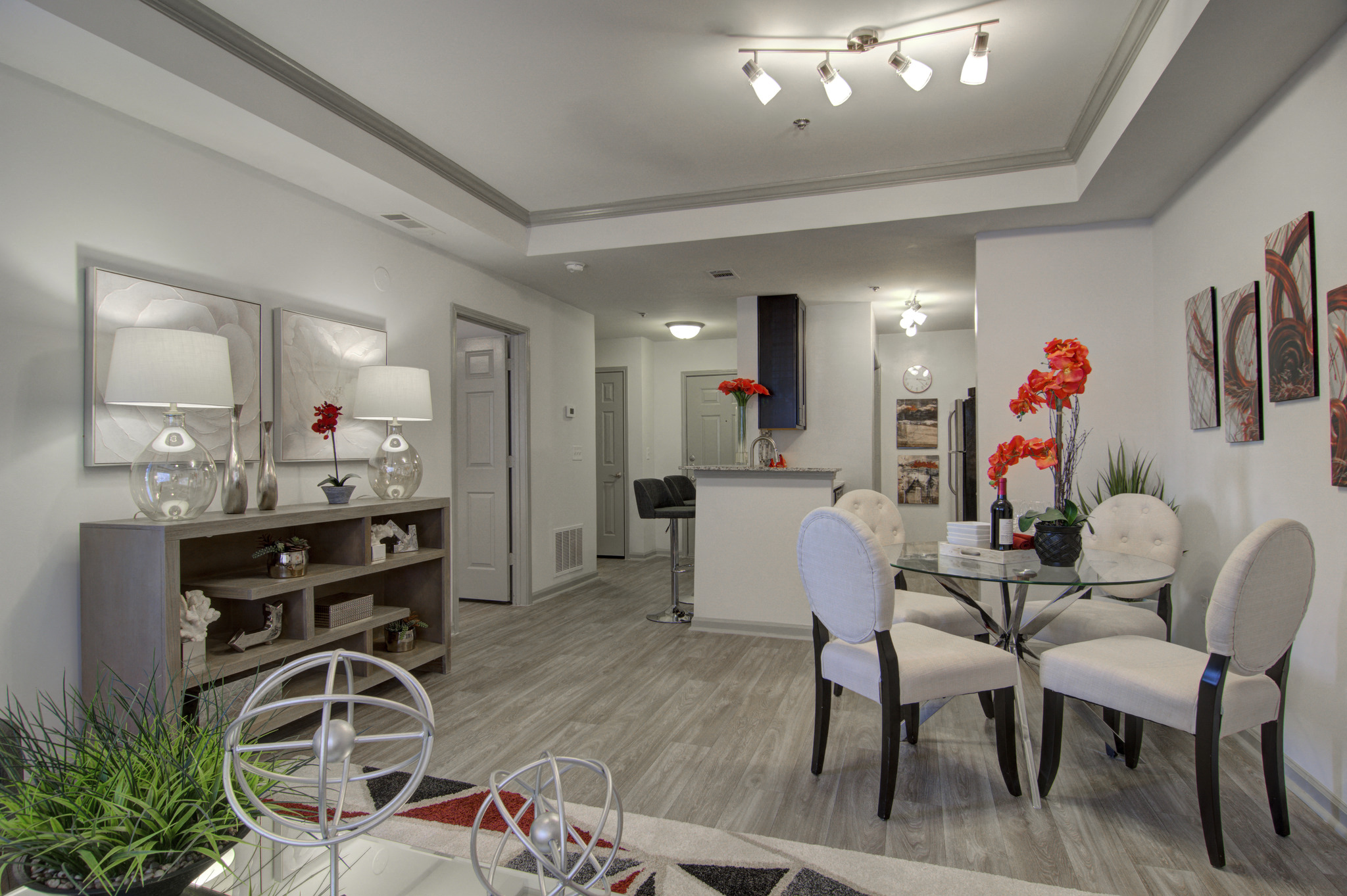a living room and dining room with a table and chairs